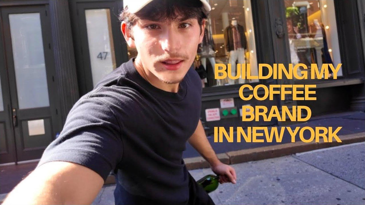 Daniel walking in SoHo holding an OLI bottle